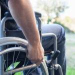 Paralyzed man using his wheelchair